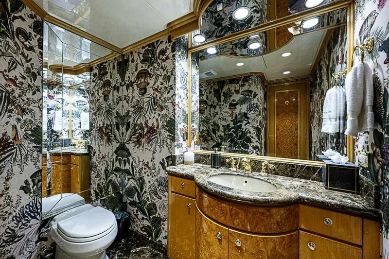 Slide: The Image of Luxurious bathroom on 1997 Delta 122 Tri-Deck Motor Yacht with elegant floral wallpaper and marble accents. - 38