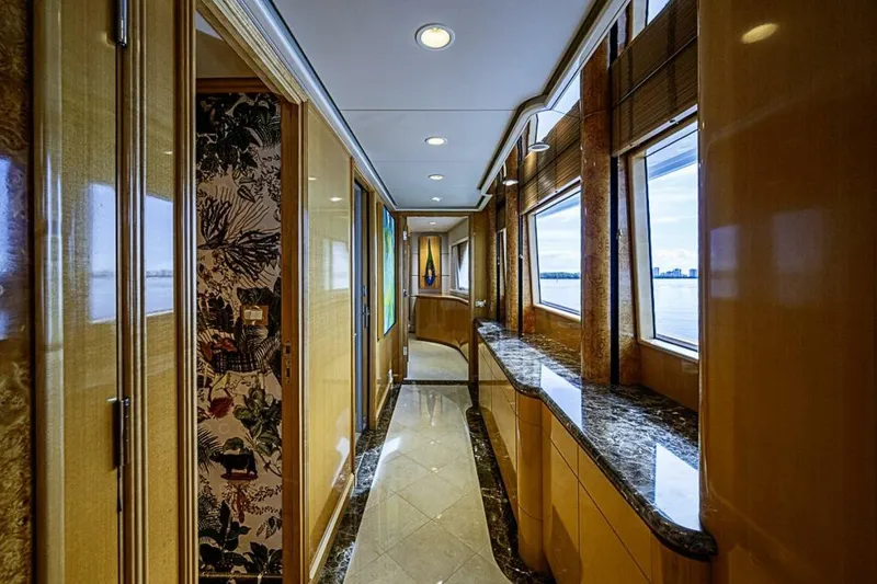 Slide: The Image of Luxurious interior hallway of 1997 Delta 122 Tri-Deck Motor Yacht with elegant wood and marble finishes. - 39
