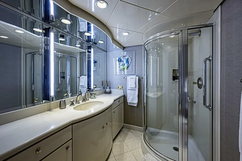 Slide: The Image of Luxurious bathroom on 1997 Delta 122 Tri-Deck Motor Yacht with modern fixtures and curved shower. - 52