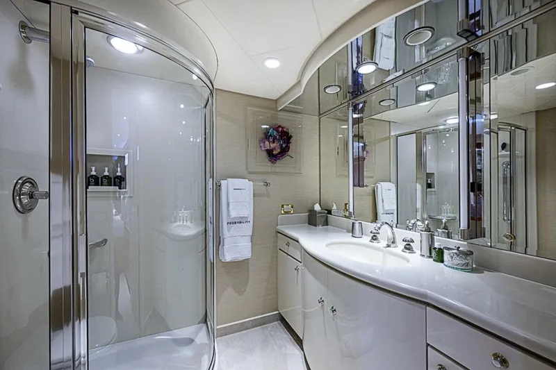Slide: The Image of Luxurious bathroom on 1997 Delta 122 Tri-Deck Motor Yacht with modern fixtures and mirrored cabinets. - 57