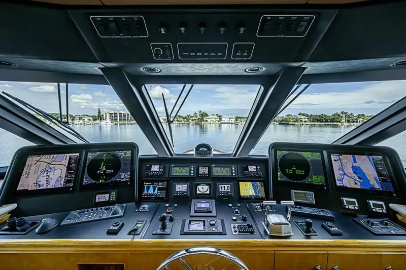 Slide: The Image of Cockpit of 1997 Delta 122 Tri-Deck Motor Yacht with navigation screens and controls. - 60