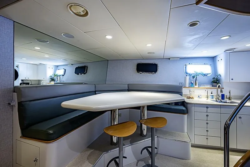 Slide: The Image of Luxurious interior of 1997 Delta 122 Tri-Deck Motor Yacht with modern dining area and kitchenette. - 65