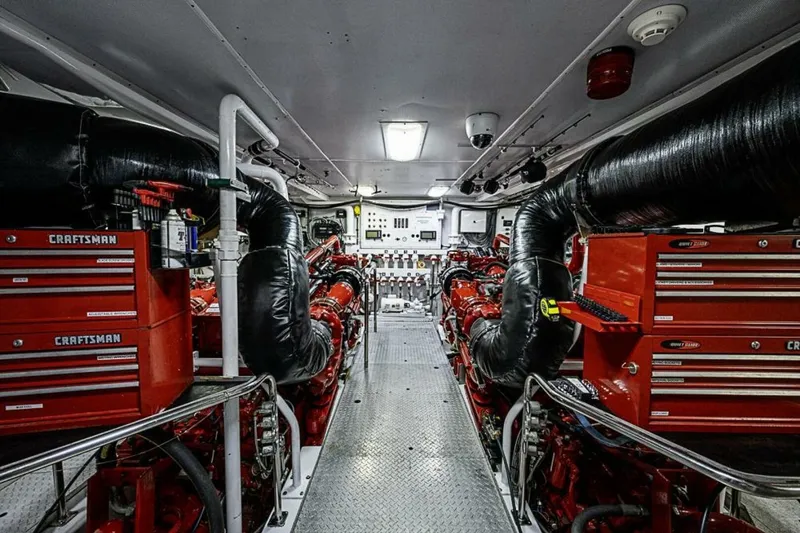 Slide: The Image of Engine room of 1997 Delta 122 Tri-Deck Motor Yacht with red Craftsman toolboxes. - 68