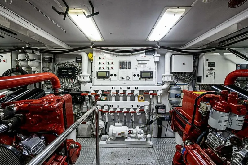 Slide: The Image of Engine room of 1997 Delta 122 Tri-Deck Motor Yacht with control panels and machinery. - 70