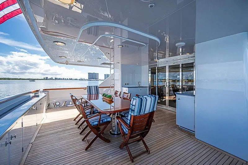 Slide: The Image of Luxurious 1997 Delta Marine yacht deck with dining area, overlooking serene waters. - 15