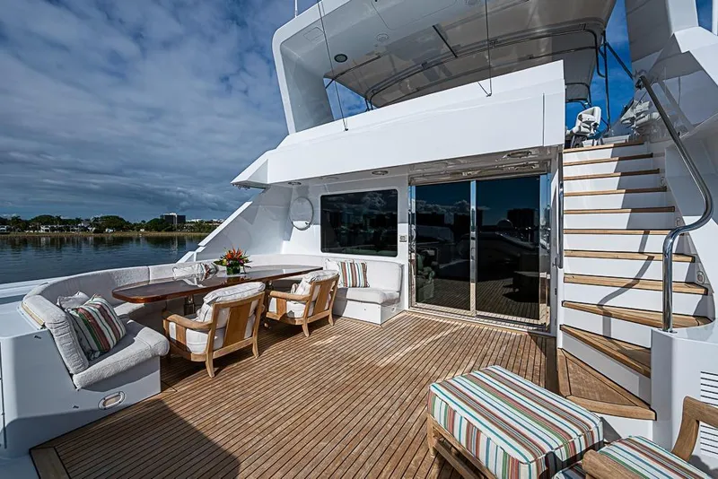 Slide: The Image of Luxurious 1997 Delta Marine yacht deck with elegant seating and scenic waterfront view. - 19