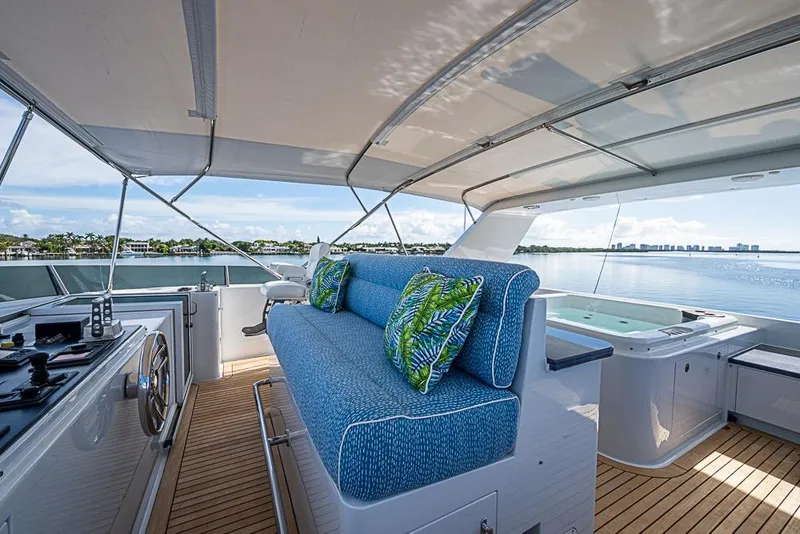 Slide: The Image of Luxurious 1997 Delta Marine yacht deck with blue seating, tropical cushions, and ocean view. - 21