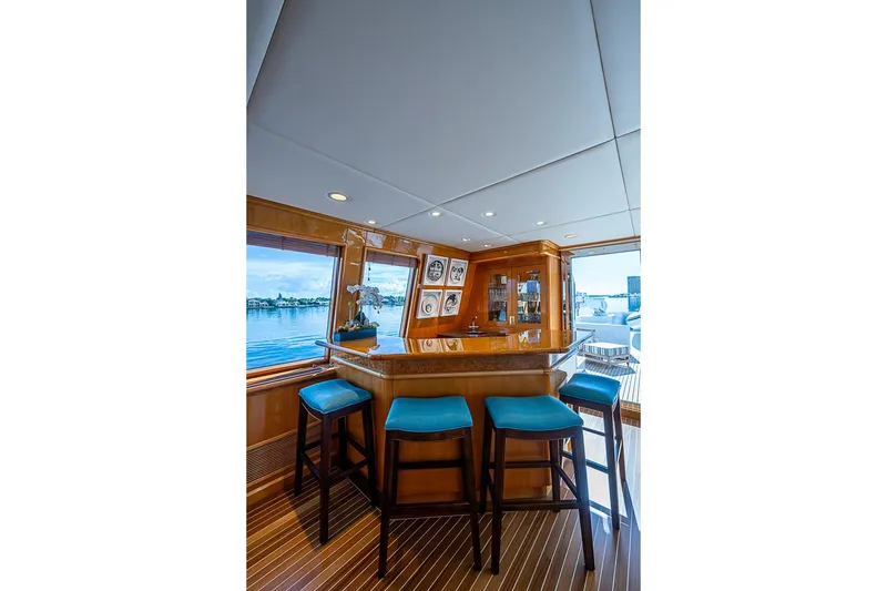 Slide: The Image of Luxurious yacht interior with bar stools, wooden finishes, and ocean view, Delta Marine 1997. - 34