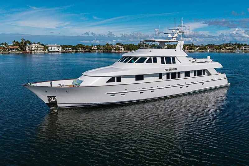 Slide: The Image of Luxury 1997 Delta Marine yacht cruising on calm waters under a clear blue sky. - 4