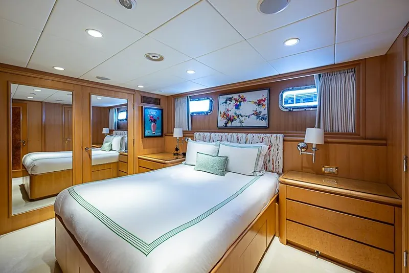 Slide: The Image of Luxurious bedroom interior on 1997 Delta Marine yacht, featuring elegant wood paneling and modern decor. - 49