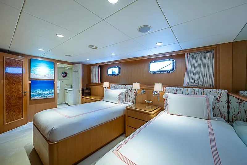 Slide: The Image of Luxurious 1997 Delta Marine yacht cabin with twin beds, elegant decor, and ocean-themed artwork. - 51