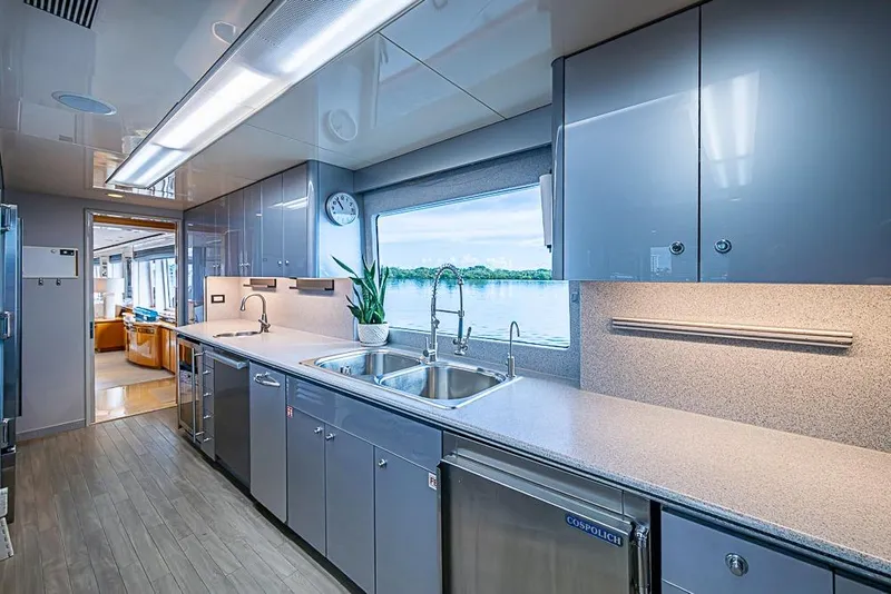 Slide: The Image of Modern yacht kitchen interior with sleek cabinetry, large window view, and stainless steel appliances, Delta Marine 1997. - 56