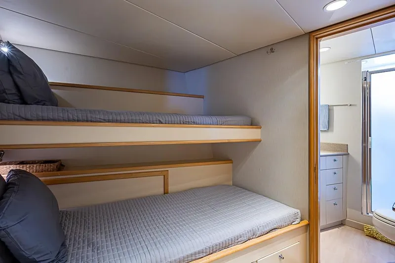 Slide: The Image of Bunk beds in a 1997 Delta Marine yacht cabin with adjacent bathroom. - 61