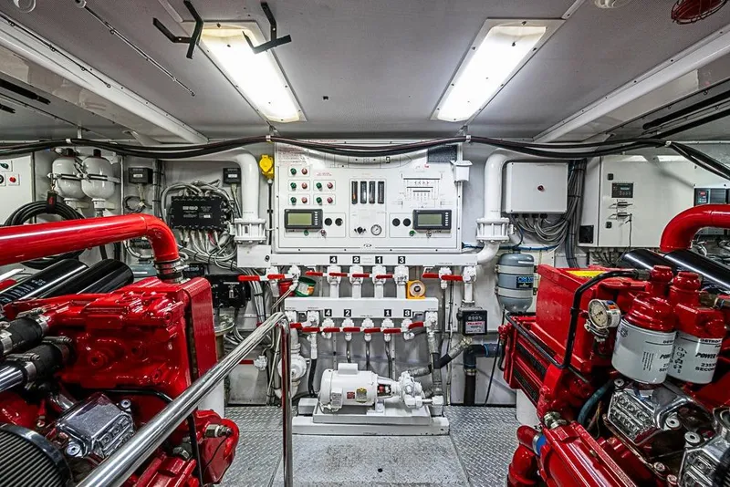 Slide: The Image of Engine room of a 1997 Delta Marine vessel with red machinery and control panels. - 64