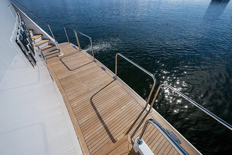 Slide: The Image of Teak deck of 1997 Delta Marine yacht with stainless steel railings over water. - 67