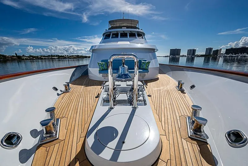 Slide: The Image of Luxury Delta Marine yacht deck, 1997 model, with polished wood and chrome details under a clear blue sky. - 68