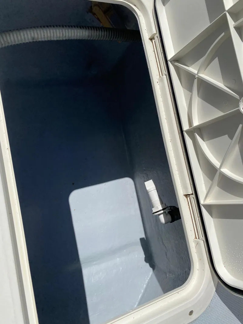 Slide: The Image of Open storage compartment on a 1995 Ocean Master 3100 boat. - 17