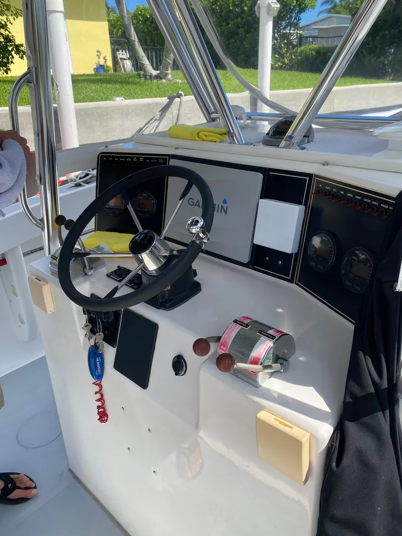 Slide: The Image of Control panel of a 1995 Ocean Master 3100 boat with steering wheel and gauges. - 8