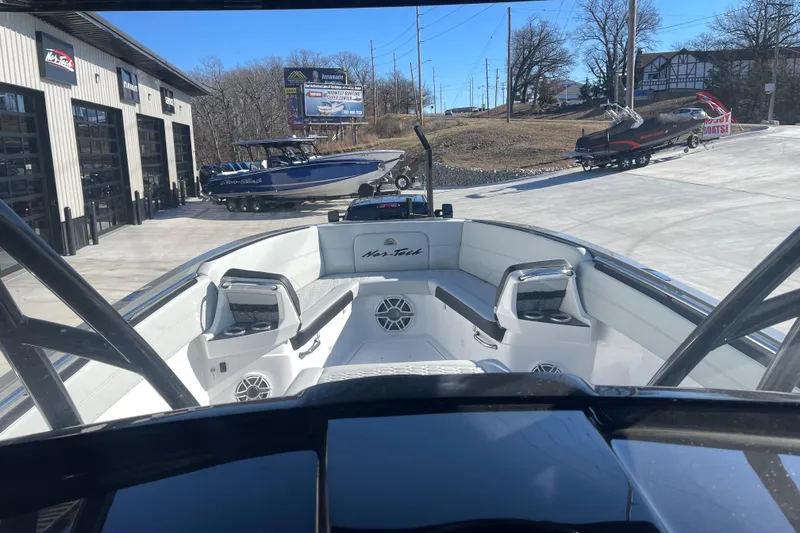 Slide: The Image of 2026 Nor- 390 Sport boat interior at dealership, showcasing sleek design and seating. - 18