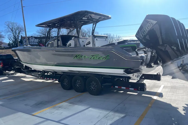 Slide: The Image of 2026 Nor-Tech 390 Sport boat on trailer, featuring sleek design and powerful engines. - 7