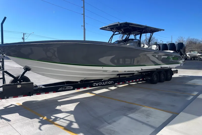 Slide: The Image of 2026 Nor- 390 Sport boat on trailer in parking lot, clear blue sky. - 8