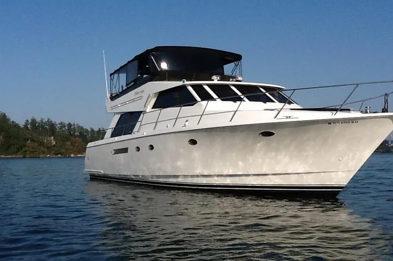 The Image of 1996 Forbes Cooper pilot house yacht on calm water under clear sky. - 0