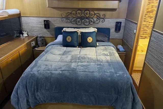 Slide: The Image of Cozy bedroom in 1996 Forbes Cooper pilot house yacht with elegant decor and plush bedding. - 12
