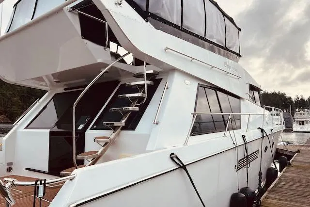 Slide: The Image of 1996 Forbes Cooper pilot house yacht docked, featuring sleek design and modern amenities. - 2