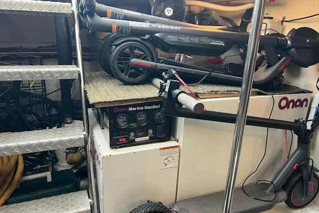Slide: The Image of Storage area in a 1996 Forbes Cooper pilot house with scooters and Onan Marine GenSet. - 22
