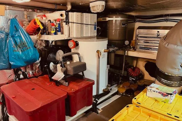 Slide: The Image of Engine room of a 1996 Forbes Cooper pilot house, featuring equipment and storage. - 26