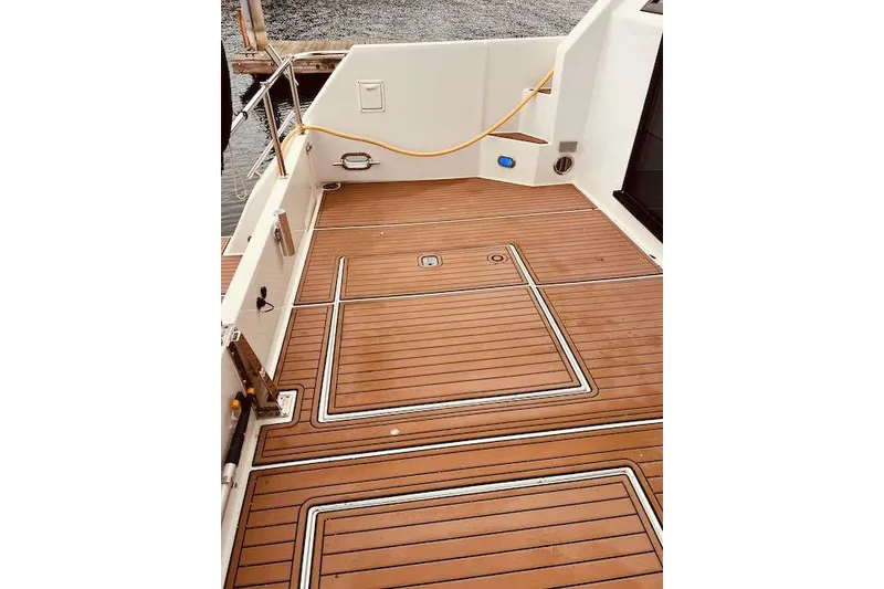 Slide: The Image of 1996 Forbes Cooper pilot house boat deck with teak flooring and dock view. - 5