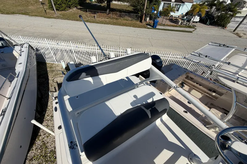 Slide: The Image of 2020 Robalo 246 Cayman SD boat interior with seating and steering wheel. - 20