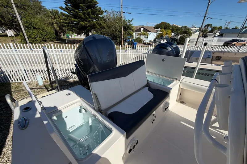 Slide: The Image of 2020 Robalo 246 Cayman SD boat interior with seating and storage compartments. - 7