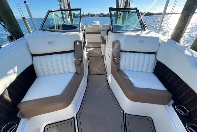 Slide: The Image of 2019 Cobalt 25SC boat with outboard motor, docked by a scenic waterfront. - 13