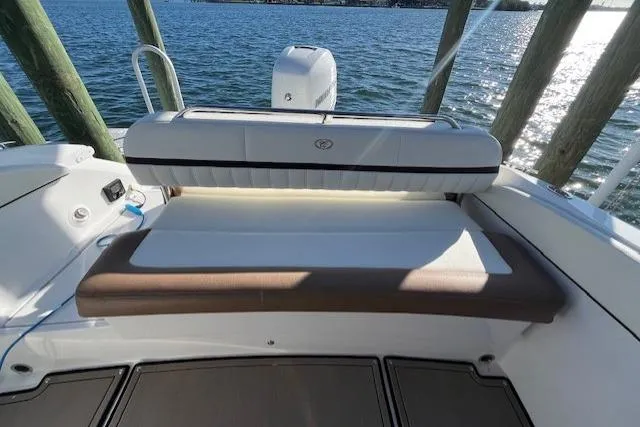 Slide: The Image of 2019 Cobalt 25SC boat interior with cushioned seating and cup holders. - 16