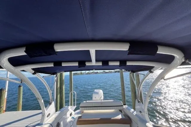 Slide: The Image of Interior view of a 2019 Cobalt 25SC boat with white and brown seating. - 17