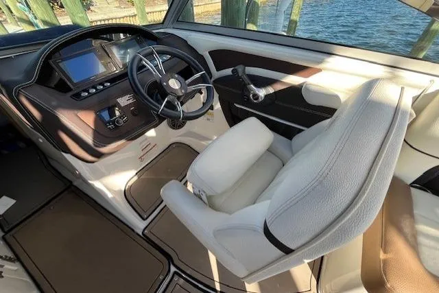 Slide: The Image of 2019 Cobalt 25SC boat with Mercury outboard engine docked by the water. - 7