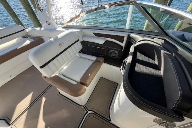Slide: The Image of 2019 Cobalt 25SC boat cockpit with steering wheel and control panel, dockside view. - 9