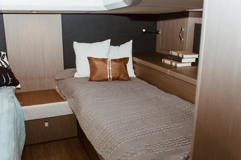 Slide: The Image of Cozy cabin interior of 2023 Beneteau Gran Turismo 41 yacht with bed and books. - 11