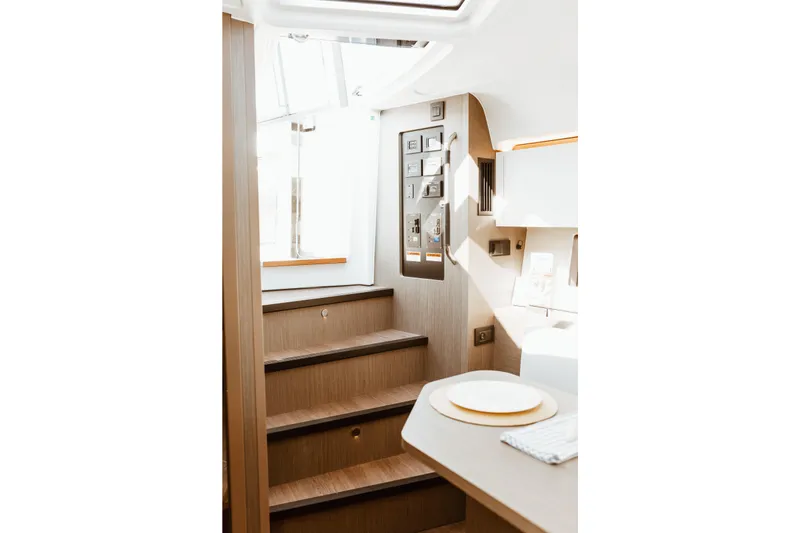 Slide: The Image of Interior of 2023 Beneteau Gran Turismo 41 yacht, featuring wooden stairs and modern design. - 14