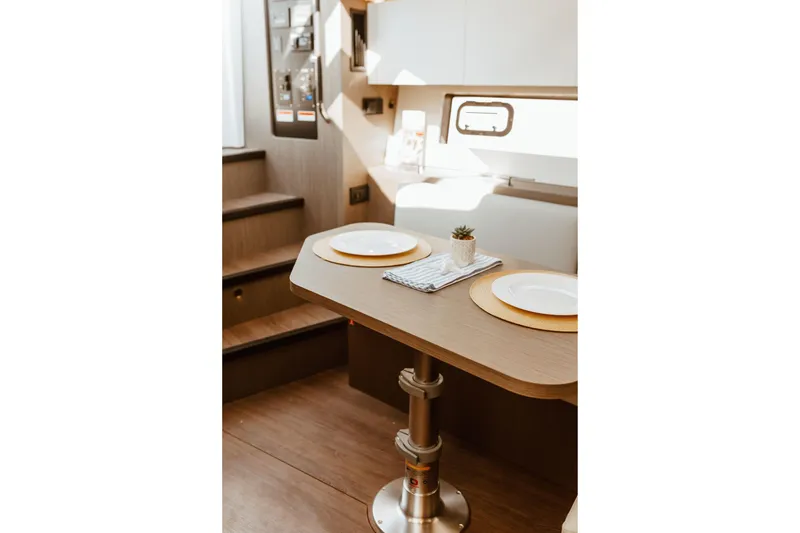 Slide: The Image of Interior of 2023 Beneteau Gran Turismo 41 yacht with elegant dining setup. - 15