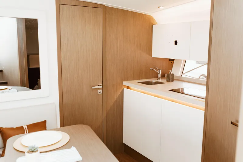 Slide: The Image of Modern kitchen interior of 2023 Beneteau Gran Turismo 41 yacht, featuring sleek design and amenities. - 18