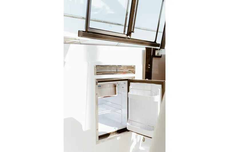 Slide: The Image of Open refrigerator on 2023 Beneteau Gran Turismo 41 yacht, showcasing modern interior design. - 21
