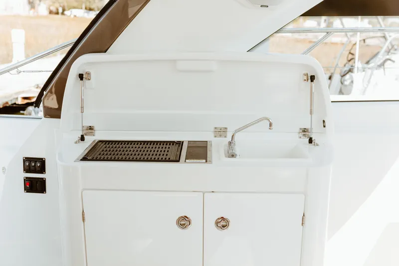 Slide: The Image of 2023 Beneteau Gran Turismo 41 yacht kitchenette with sink and grill. - 22