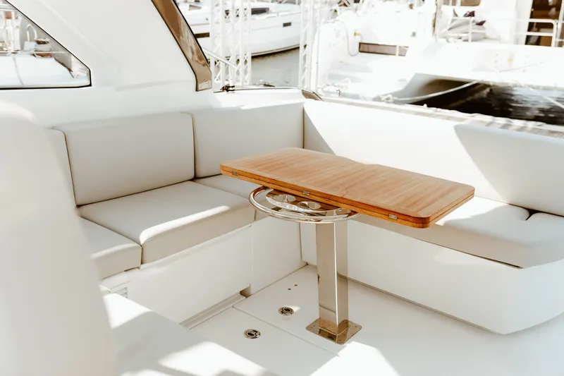Slide: The Image of Luxurious seating area on 2023 Beneteau Gran Turismo 41 yacht with wooden table. - 24