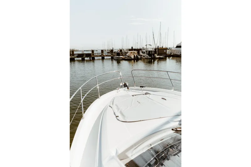 Slide: The Image of 2023 Beneteau Gran Turismo 41 yacht docked at a marina, showcasing sleek design. - 3