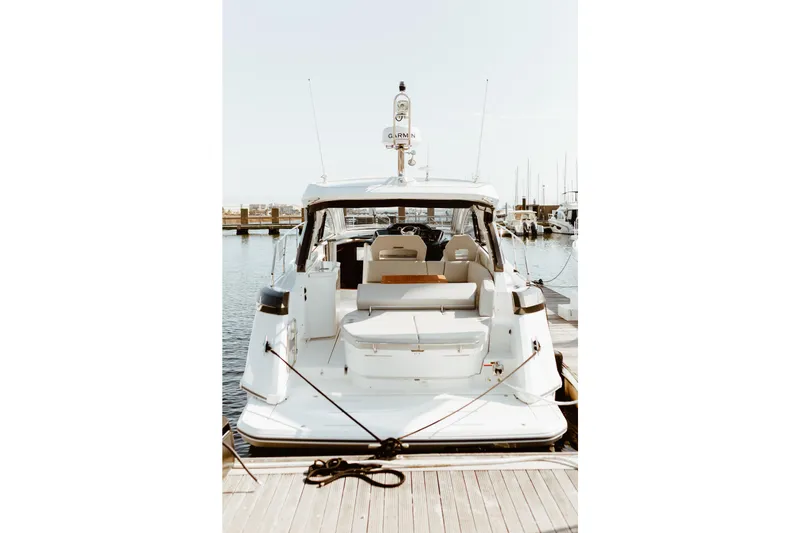 Slide: The Image of 2023 Beneteau Gran Turismo 41 yacht docked at marina, rear view. - 31