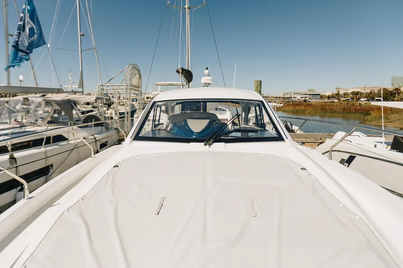 Slide: The Image of 2023 Beneteau Gran Turismo 41 yacht docked at marina under clear blue sky. - 5