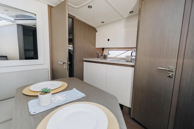 Slide: The Image of Interior of 2023 Beneteau Gran Turismo 41 yacht, featuring modern kitchen and dining area. - 8