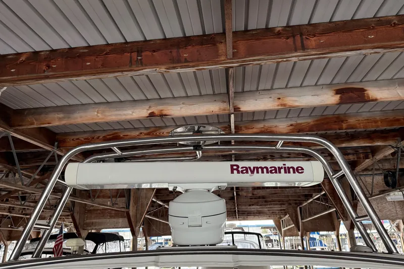 Slide: The Image of 1985 Bayliner 4550 Motoryacht deck with davit system and docked boats in background. - 102